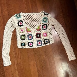 Crochet cardigan with a funky design. Cute festival look. Size small.